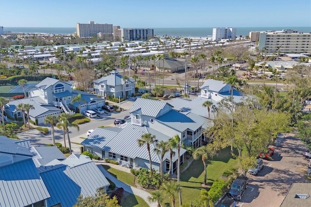 drone / aerial view featuring a view of city and a water view