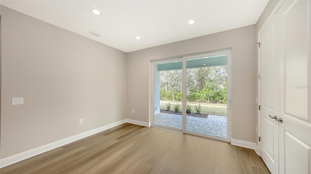 unfurnished room with recessed lighting, baseboards, visible vents, and light wood finished floors