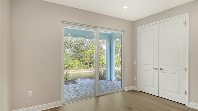 entryway with recessed lighting, baseboards, and wood finished floors