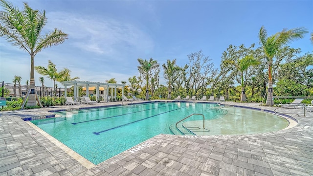 pool featuring a pergola, a patio, and fence