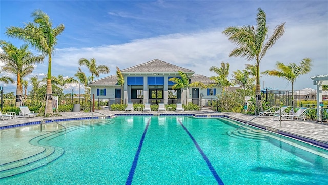 pool with a patio and fence