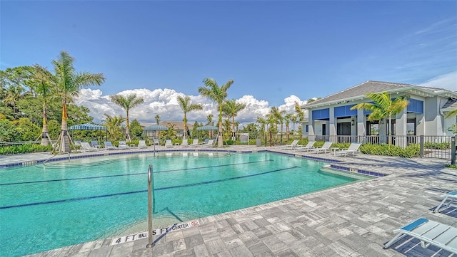 community pool featuring a patio and fence