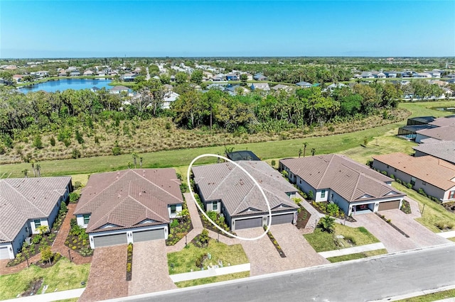 drone / aerial view featuring a residential view and a water view