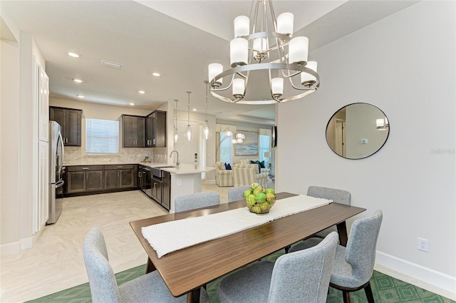 dining room with recessed lighting, baseboards, and a notable chandelier