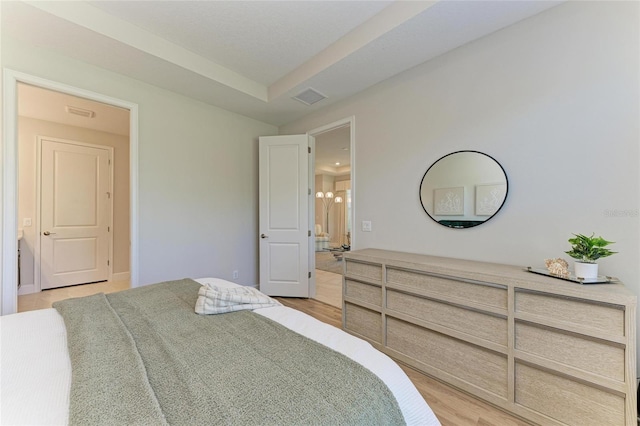 bedroom with visible vents and light wood-style flooring