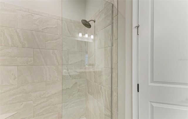 interior details featuring a tile shower