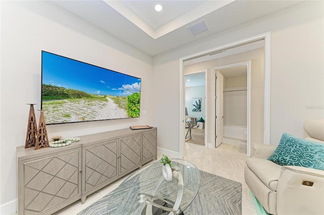 living room featuring baseboards and visible vents