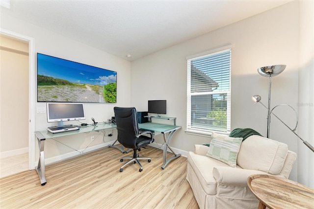 office area featuring baseboards and light wood-style floors