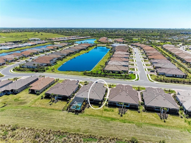 birds eye view of property with a residential view and a water view