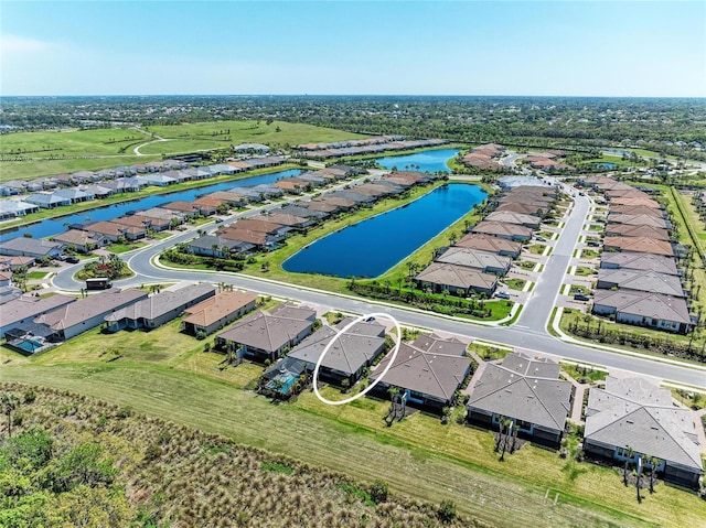 bird's eye view featuring a water view and a residential view