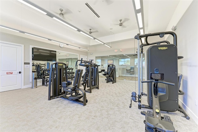 gym with ceiling fan, baseboards, and carpet