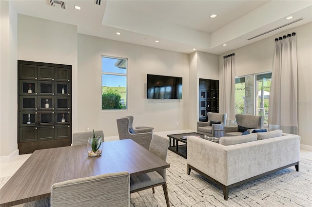 living room featuring visible vents, recessed lighting, baseboards, and a healthy amount of sunlight