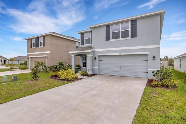 traditional home featuring concrete driveway, an attached garage, and stucco siding