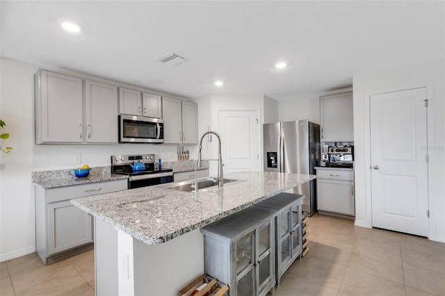 kitchen with gray cabinetry and stainless steel appliances