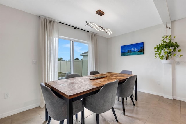 dining room with light tile patterned floors and baseboards