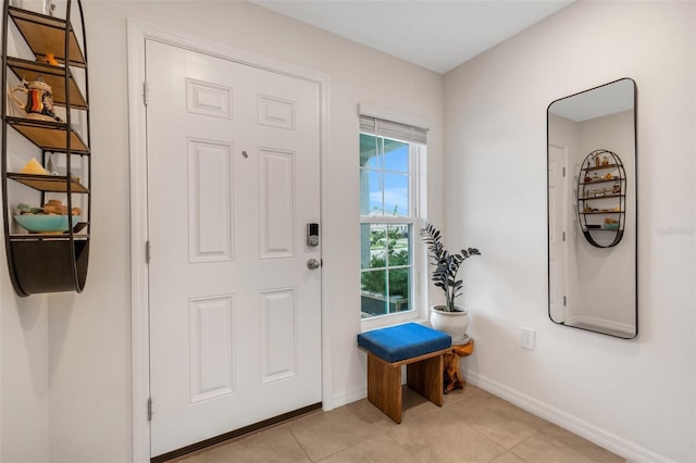 entrance foyer featuring light tile patterned floors and baseboards