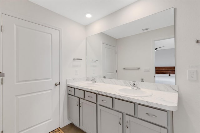 bathroom featuring a sink, visible vents, ensuite bathroom, and double vanity