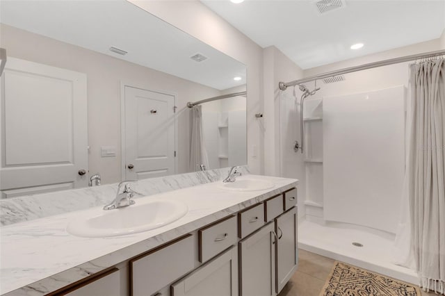 bathroom with a sink, visible vents, and a shower stall