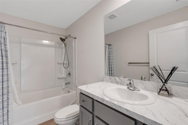 bathroom with vanity, shower / tub combo, toilet, and visible vents