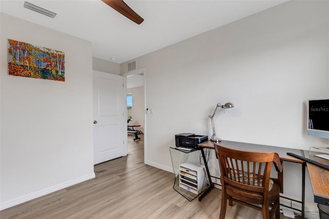 office featuring visible vents, baseboards, and wood finished floors