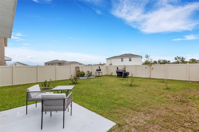 view of yard with a patio area and a fenced backyard