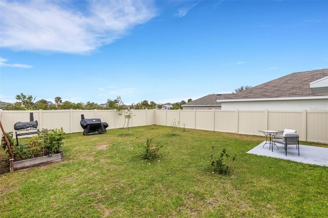 view of yard with a patio, a vegetable garden, and a fenced backyard