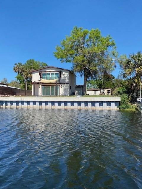 back of house with a water view