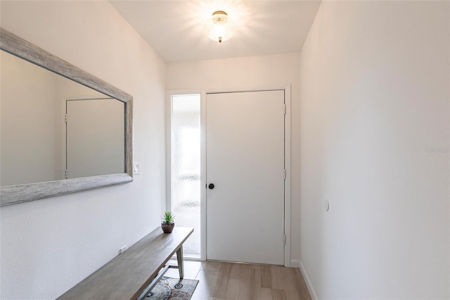 entryway with light wood-style floors and baseboards