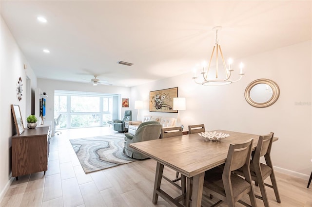 dining space with baseboards, visible vents, recessed lighting, ceiling fan with notable chandelier, and light wood-type flooring