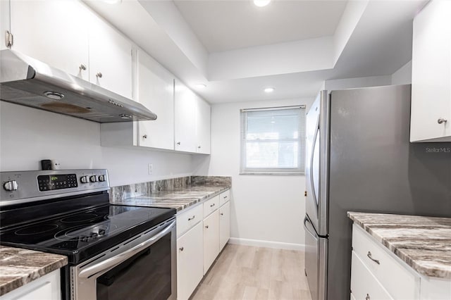 kitchen featuring light stone countertops, light wood-style flooring, stainless steel appliances, white cabinets, and under cabinet range hood