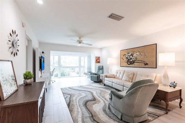 living area with recessed lighting, visible vents, and a ceiling fan