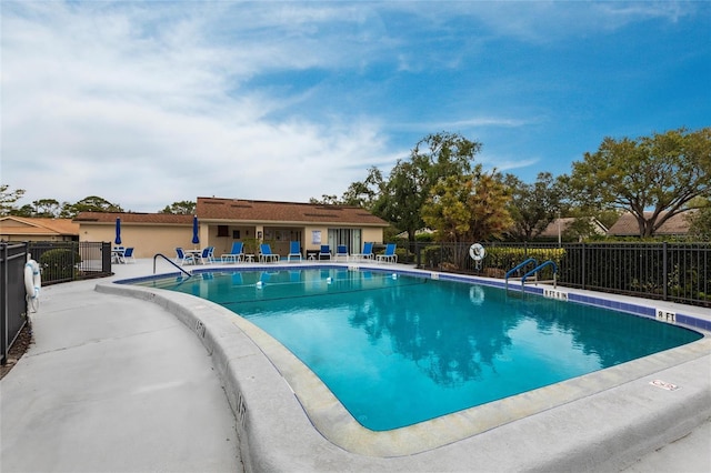 pool featuring a patio and fence