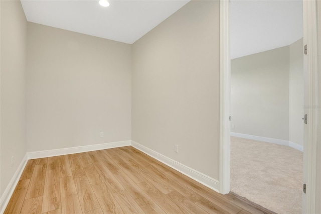 empty room with recessed lighting, light wood-style floors, and baseboards