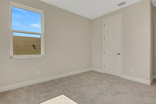 carpeted empty room with baseboards and visible vents