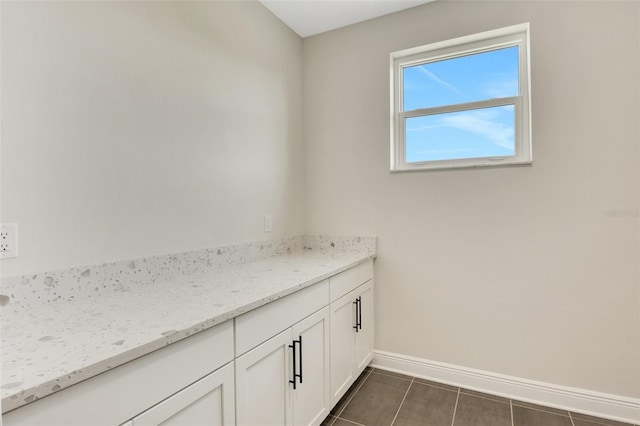 bathroom featuring tile patterned flooring and baseboards