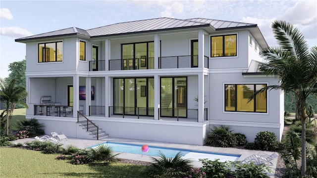 rear view of house with an outdoor pool, stucco siding, a balcony, and metal roof