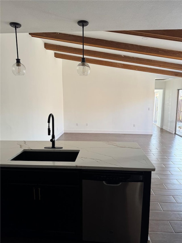 kitchen with pendant lighting, beam ceiling, light stone counters, stainless steel dishwasher, and a sink