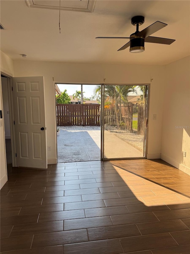 doorway with visible vents, dark wood-style floors, baseboards, and ceiling fan