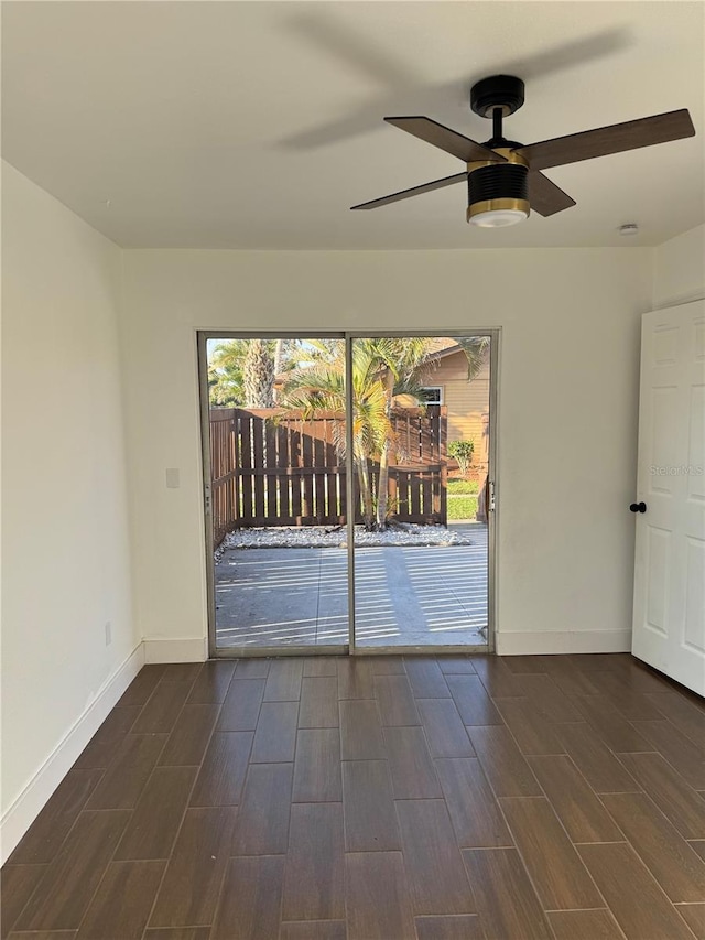 empty room with ceiling fan, baseboards, and wood finish floors