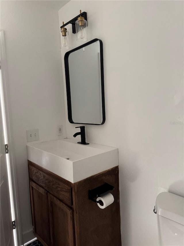 bathroom featuring vanity and toilet