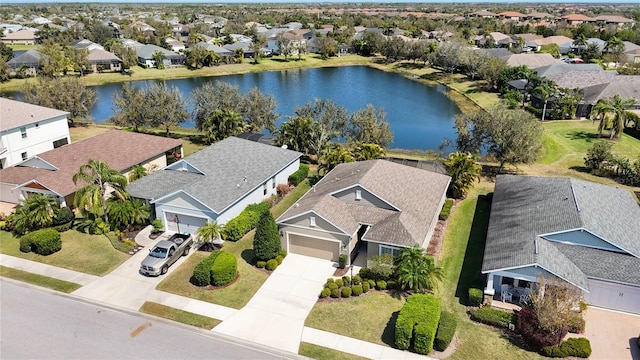 birds eye view of property with a residential view and a water view