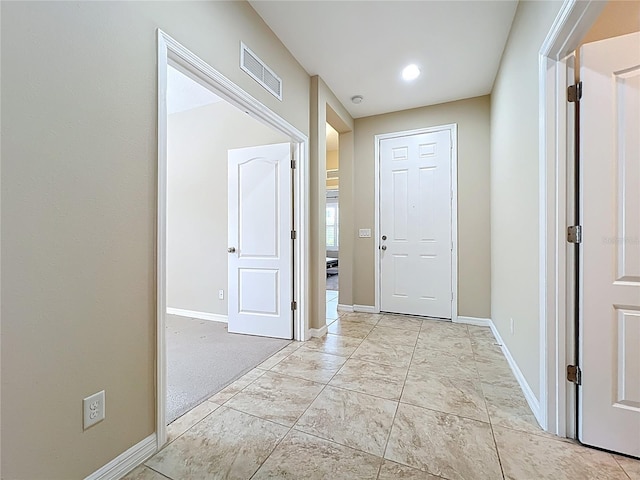 corridor with visible vents and baseboards