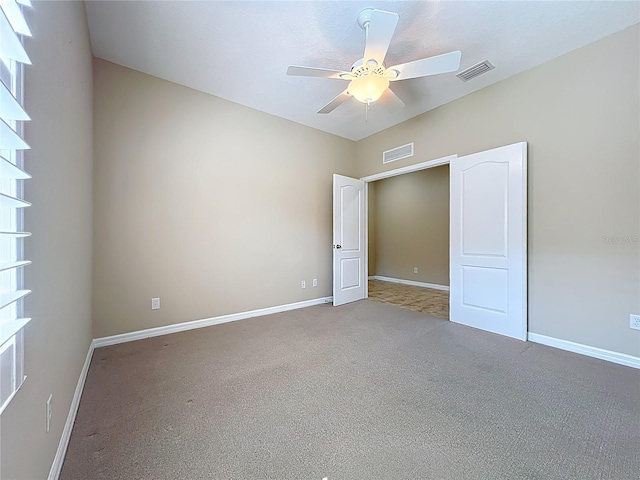 spare room featuring a ceiling fan, baseboards, and visible vents