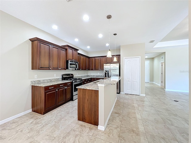 kitchen with a center island with sink, light stone counters, decorative light fixtures, a sink, and stainless steel appliances