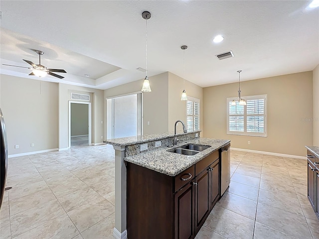 kitchen with baseboards, visible vents, a sink, dark brown cabinets, and dishwasher