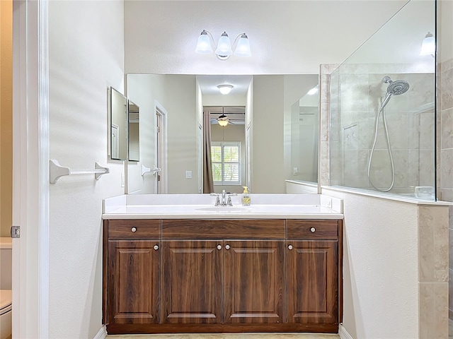 full bath featuring vanity, toilet, ceiling fan, and walk in shower