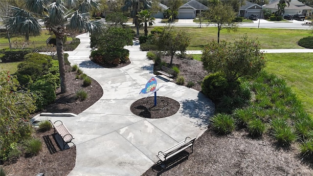 view of property's community featuring a yard and fence