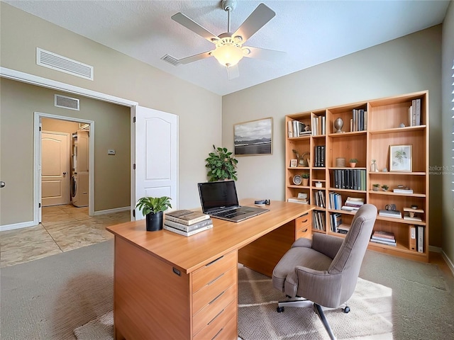 office area featuring visible vents, light colored carpet, and a ceiling fan