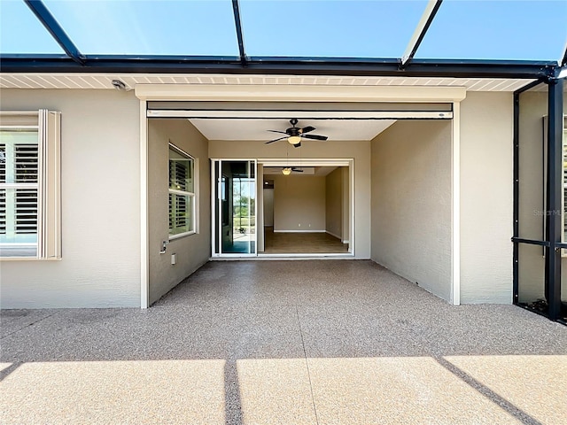 property entrance featuring stucco siding, a garage, and a patio area