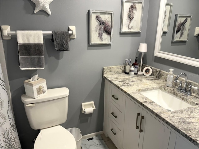 bathroom with baseboards, toilet, marble finish floor, and vanity